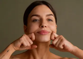 Woman demonstrating jaw muscle pressure related to MJ trigger points