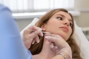 This image shows a patient undergoing a Masseter Botox procedure, where Botox is injected into the jaw muscle to reduce jaw tension, treat teeth grinding and TMJ, and improve facial contouring. Masseter Botox is a non-surgical treatment commonly used for both medical and aesthetic purposes.